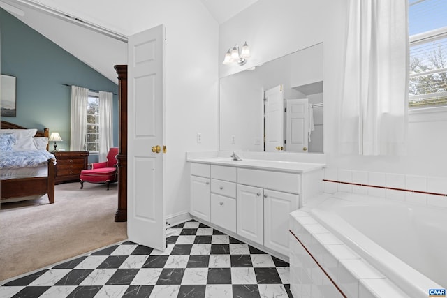 bathroom with vaulted ceiling, plenty of natural light, and ensuite bathroom
