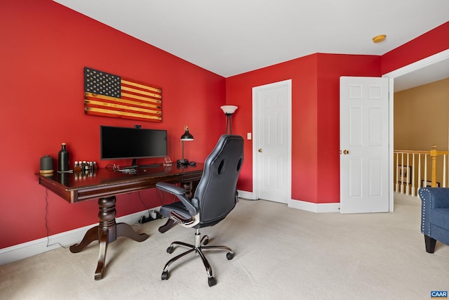 carpeted home office featuring baseboards