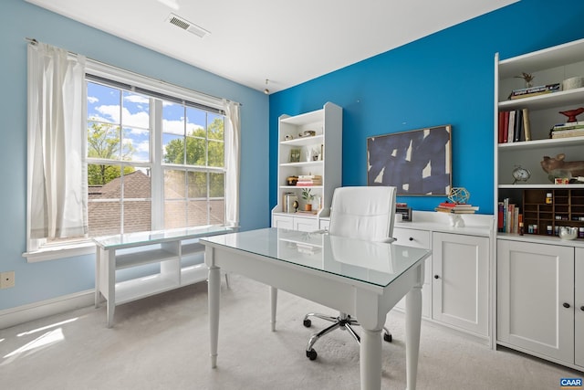 office area featuring visible vents and light carpet