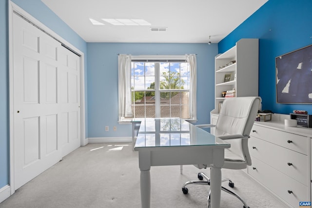 home office featuring baseboards, light colored carpet, and visible vents