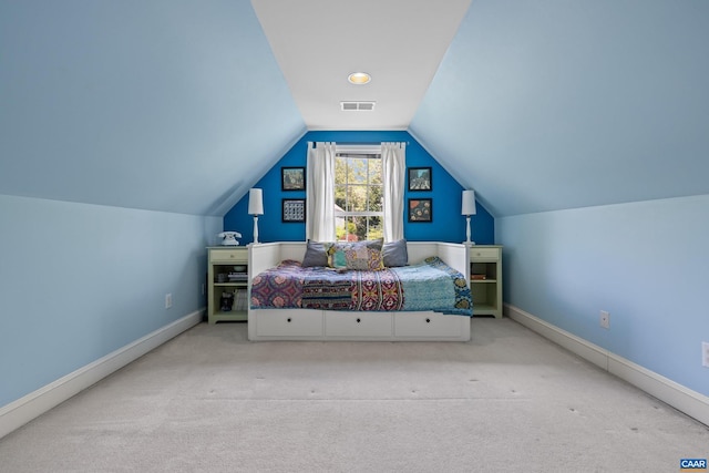 carpeted bedroom with baseboards, visible vents, and vaulted ceiling