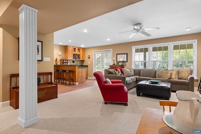 living area with baseboards, indoor wet bar, recessed lighting, and light colored carpet