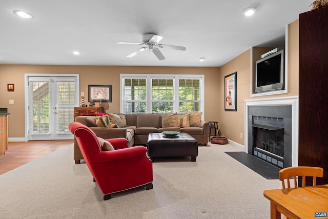 living area with recessed lighting, baseboards, a fireplace with flush hearth, and a wealth of natural light