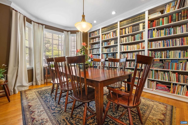 interior space featuring crown molding, recessed lighting, light wood finished floors, and built in shelves