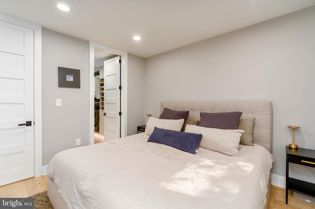 430 15th St SE, Washington, DC 20003 - bedroom featuring recessed lighting, a walk in closet, baseboards, and light wood finished floors