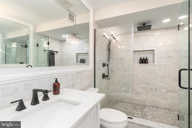 430 15th St SE, Washington, DC 20003 - full bath with visible vents, vanity, toilet, tile walls, and a stall shower