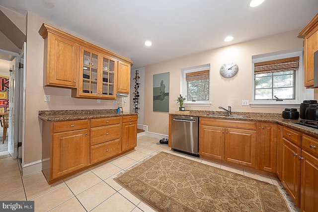 701 Argyle Rd, Wynnewood, PA 19096 - kitchen featuring stainless steel dishwasher, dark stone countertops, light tile patterned flooring, brown cabinets, and recessed lighting