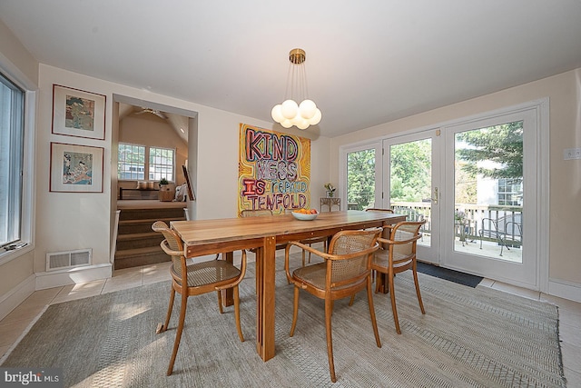701 Argyle Rd, Wynnewood, PA 19096 - dining space featuring light tile patterned floors, baseboards, stairway, a chandelier, and ceiling fan