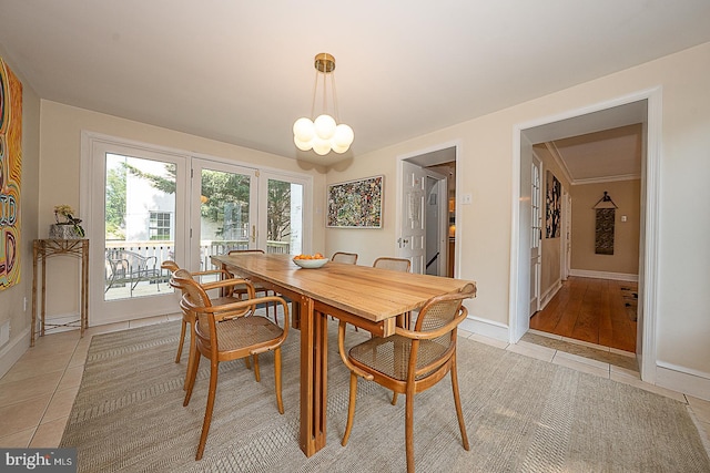 701 Argyle Rd, Wynnewood, PA 19096 - dining area featuring light tile patterned flooring, baseboards, and a chandelier