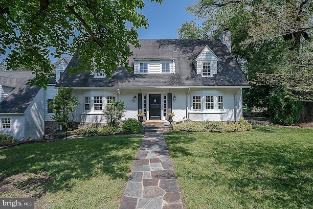 701 Argyle Rd, Wynnewood, PA 19096 - new england style home featuring a chimney, a front lawn, and brick siding