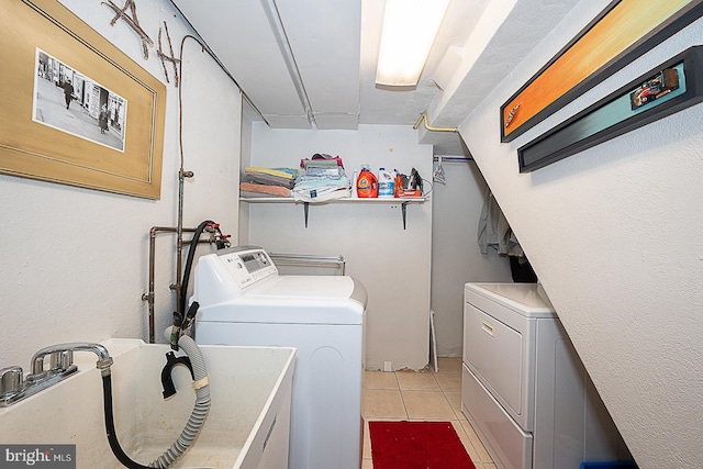 701 Argyle Rd, Wynnewood, PA 19096 - laundry room featuring washing machine and clothes dryer, light tile patterned floors, and a sink