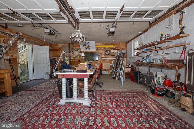 701 Argyle Rd, Wynnewood, PA 19096 - garage featuring a workshop area, a garage door opener, and wooden walls