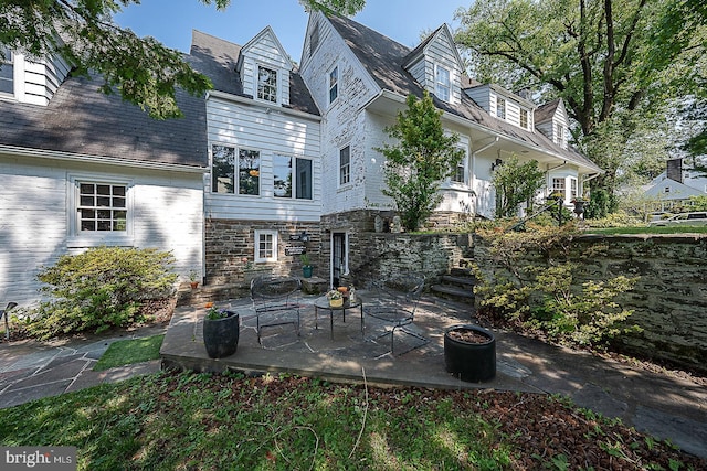 701 Argyle Rd, Wynnewood, PA 19096 - rear view of property featuring a patio area, a fire pit, stone siding, and stairway