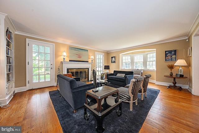 701 Argyle Rd, Wynnewood, PA 19096 - living room with wood-type flooring, crown molding, plenty of natural light, baseboards, and a glass covered fireplace