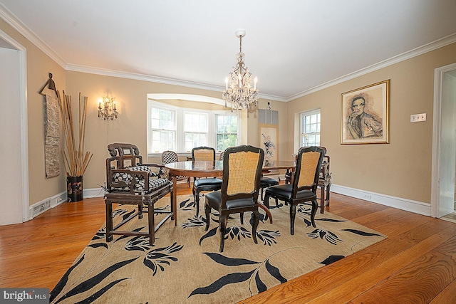701 Argyle Rd, Wynnewood, PA 19096 - dining space with wood finished floors, crown molding, a chandelier, and baseboards