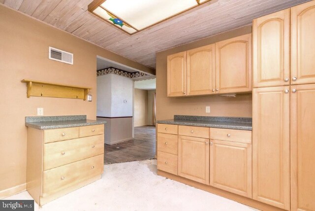 kitchen with visible vents, baseboards, light brown cabinets, and wooden ceiling