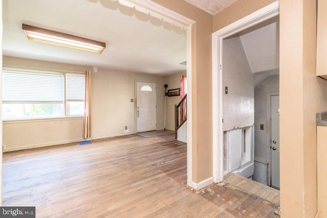 entrance foyer featuring stairway, baseboards, wood finished floors, and visible vents