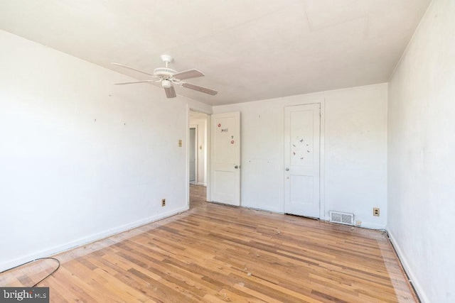 unfurnished bedroom featuring visible vents, baseboards, ceiling fan, and light wood-type flooring