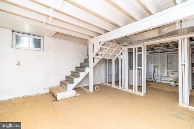 unfinished basement featuring stairway