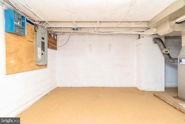 unfinished below grade area with electric panel and concrete block wall