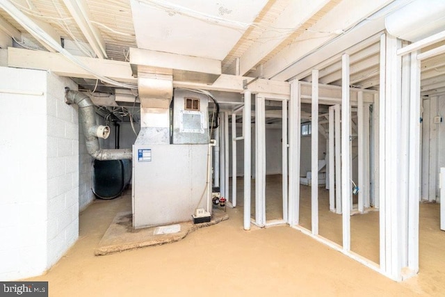 unfinished below grade area with visible vents and heating unit