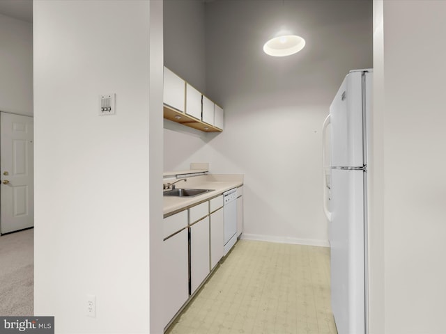 6605 Rapid Water Way Unit 301, Glen Burnie, MD 21060 - kitchen featuring white appliances, a sink, white cabinetry, light countertops, and baseboards