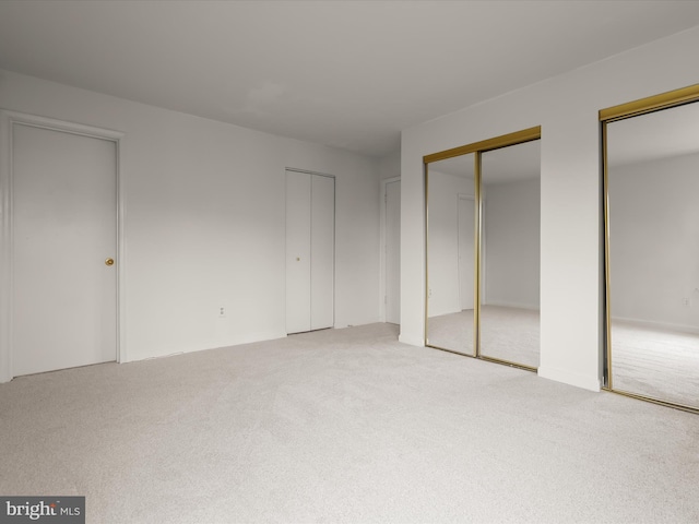 6605 Rapid Water Way Unit 301, Glen Burnie, MD 21060 - unfurnished bedroom with light carpet and two closets