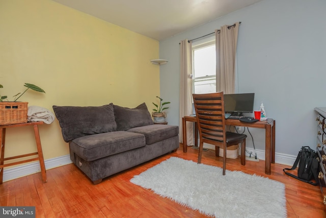 office area with baseboards and wood finished floors