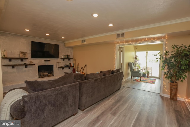 living room featuring visible vents, a fireplace with raised hearth, and baseboards
