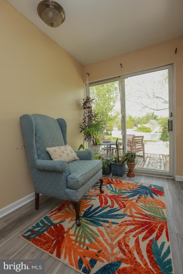 sitting room featuring baseboards and wood finished floors