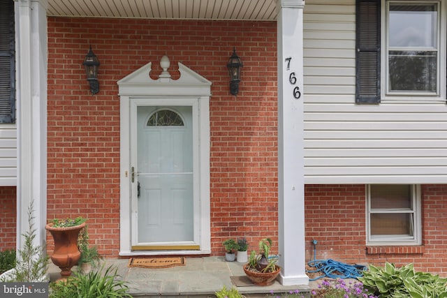 property entrance with brick siding