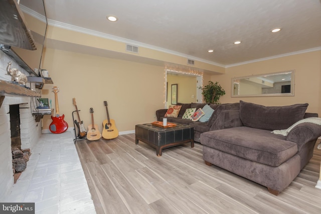 living room with visible vents, recessed lighting, a brick fireplace, and ornamental molding