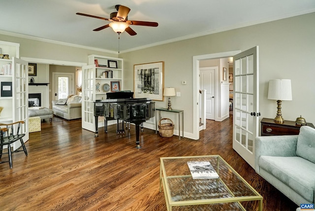living area with crown molding, ceiling fan, and french doors