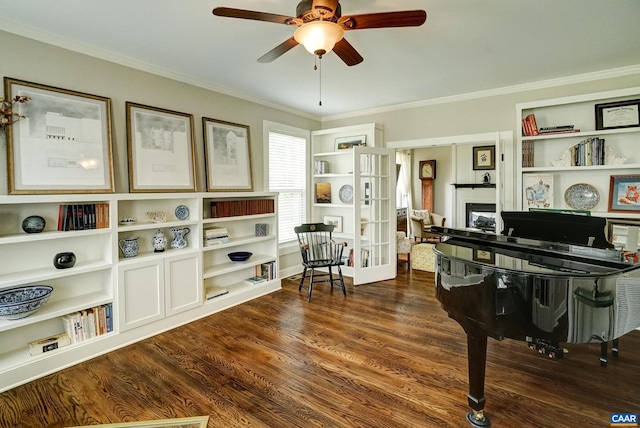 living area featuring a ceiling fan, ornamental molding, and wood finished floors