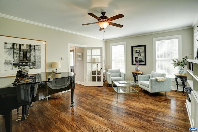 living area featuring baseboards, ornamental molding, ceiling fan, and wood finished floors
