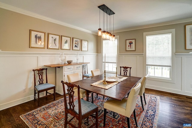 dining area with ornamental molding, a decorative wall, dark wood-style floors, and a wainscoted wall