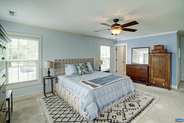 bedroom with baseboards, crown molding, visible vents, and light carpet