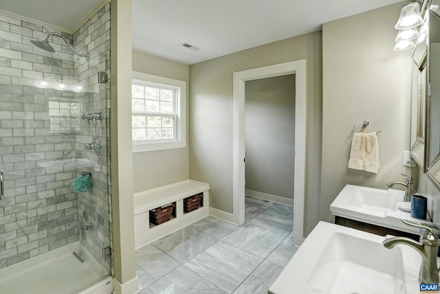bathroom featuring visible vents, a sink, marble finish floor, and a stall shower