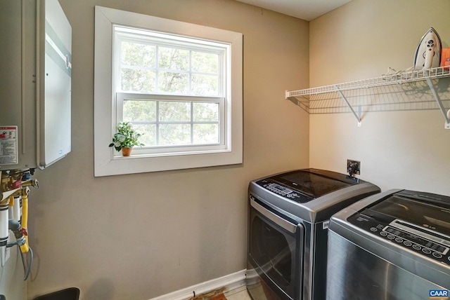 laundry room with baseboards, laundry area, and washer and clothes dryer