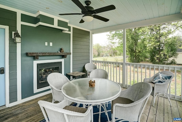 wooden deck with a ceiling fan and outdoor dining space