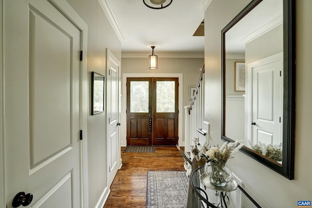 foyer with ornamental molding and dark wood-type flooring
