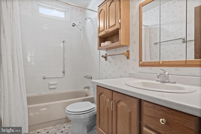 full bathroom with vanity, toilet, wallpapered walls, and shower / tub combo