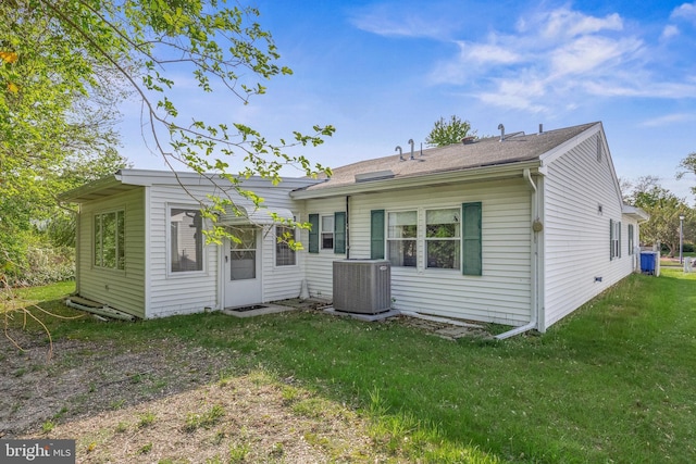 back of house with a lawn and cooling unit