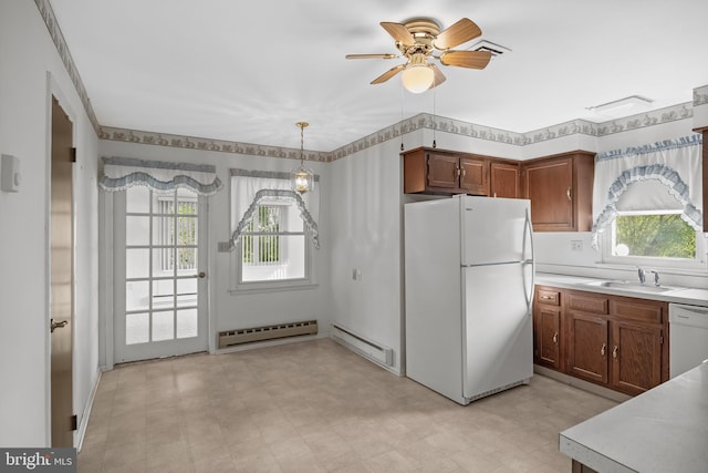 kitchen with white appliances, a sink, plenty of natural light, and baseboard heating