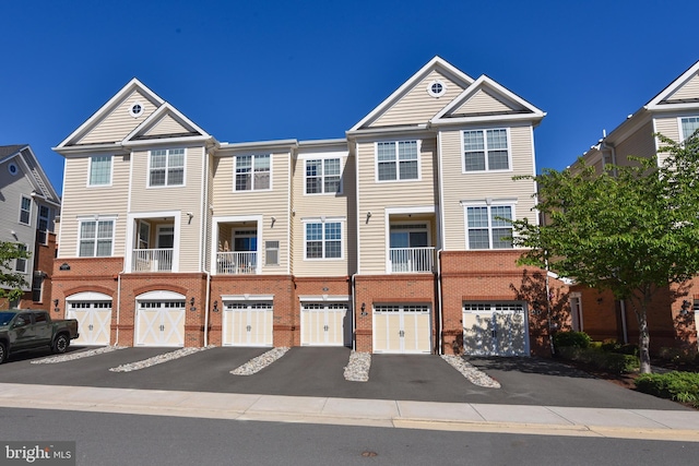 23286 Southdown Manor Ter Unit 108, Ashburn, VA 20148 - townhome / multi-family property featuring brick siding, driveway, and a garage