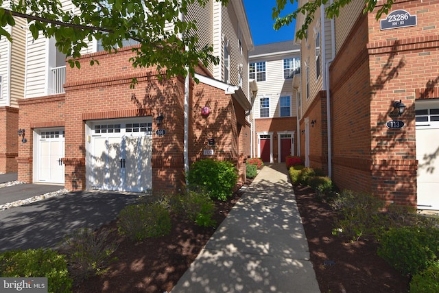 23286 Southdown Manor Ter Unit 108, Ashburn, VA 20148 - townhome / multi-family property featuring brick siding, a garage, and driveway
