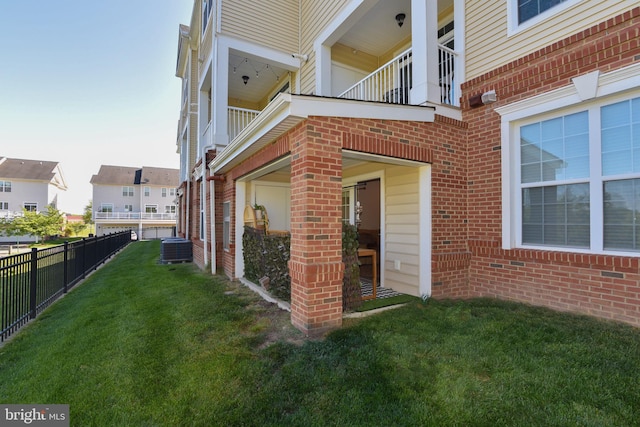 23286 Southdown Manor Ter Unit 108, Ashburn, VA 20148 - view of side of home featuring fence, central AC unit, a yard, and brick siding