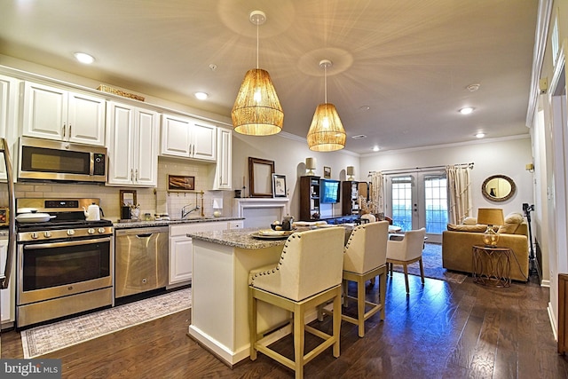23286 Southdown Manor Ter Unit 108, Ashburn, VA 20148 - kitchen with french doors, crown molding, dark wood-style floors, open floor plan, and stainless steel appliances