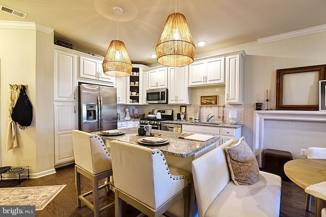 23286 Southdown Manor Ter Unit 108, Ashburn, VA 20148 - kitchen with ornamental molding, light stone countertops, stainless steel appliances, and white cabinetry
