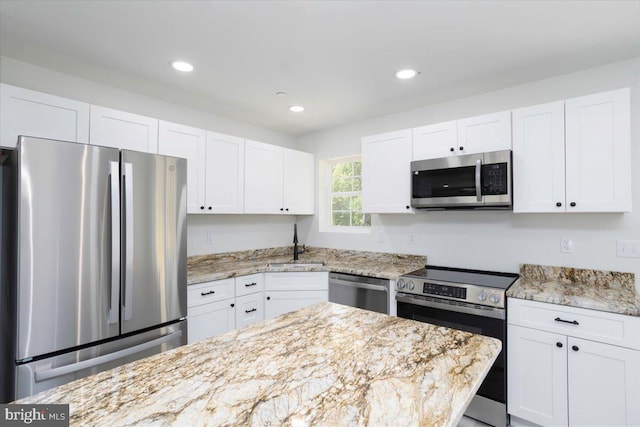 4205 Cabin Creek Hurlock Rd, Hurlock, MD 21643 - kitchen with appliances with stainless steel finishes, a sink, light stone counters, recessed lighting, and white cabinetry